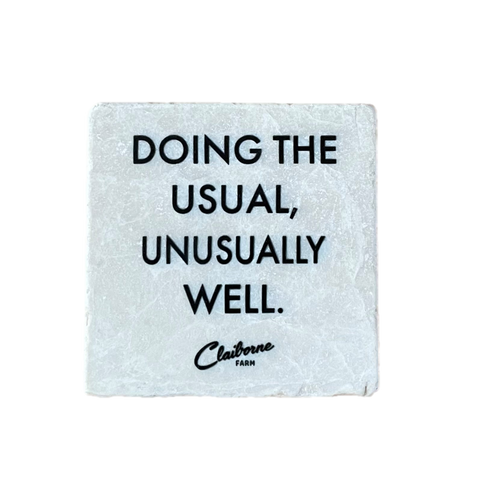 "Doing the Usual, Unusually Well" Motto Marble Coaster