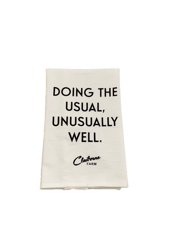 "Doing the Usual, Unusually Well" Motto Tea Towel